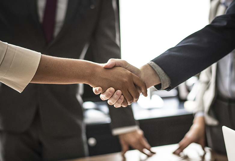 an employee and employer shaking hands after agreeing to a pay-rise